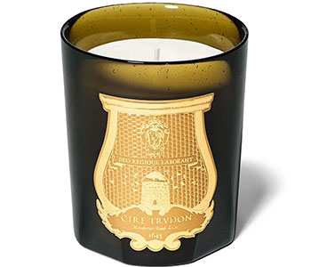 A black candle jar with a golden design.
