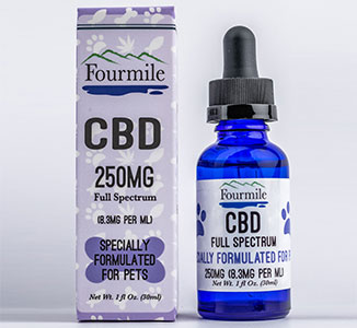 A light blue box and a blue glass container of CBD for pets from Fourmile.