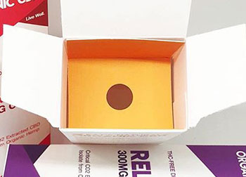 A white box opened to see the orange inside.