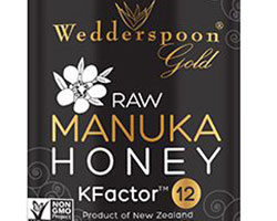 A dark label with golden foil that reads "Raw Manuka Honey".