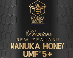 A honey label that reads "Premium New Zealand Manuka Honey" on a black matte box.