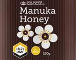 "Manuka Honey" and a flower design on a brown background.