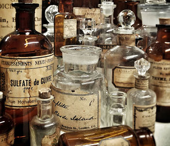 Glass bottles with vintage labels that make the bottles seem antique.