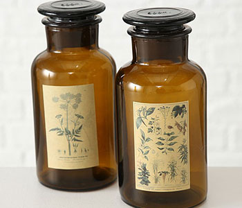Two glass bottles with black lids and traditional labels with leaves.