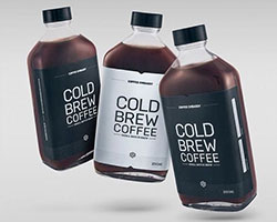 Three bottles with one white label and two black label that read "Cold Brew Coffee".