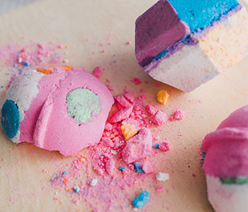 A crumbled bath bomb in multiple colors.