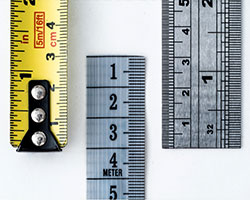 A yellow ruler followed by two gray ones.
