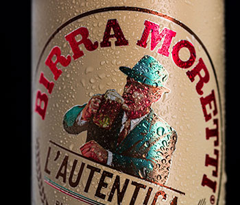 Close up on label design for Birra Moretti with condensed water on it.