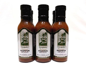 Bottles of barbecue sauce with black lid and white label that reads "Moppin".