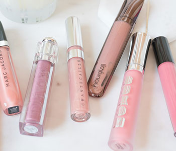 Pink glass tube containers for lip glosses.