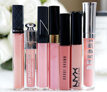 Pink lip glosses in various sizes with black lids.