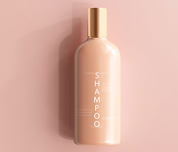 A pink bottle with a golden lid and a label that reads "Shampoo".