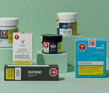 Multiple cannabis products in various boxes and containers.