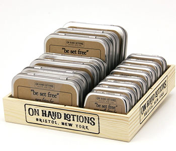 Metal boxes in a bigger cardboard that reads "On Hand Lotions".