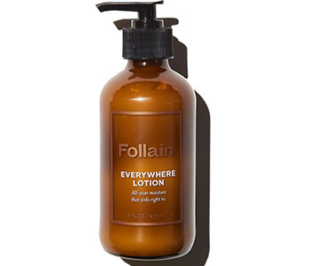 A brown container with a pump lid and a label that reads "Follain Everywhere Lotion".