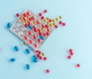 Colored vitamins spread across a blue background.