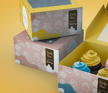 Pink and yellow cupcake boxes with a small dark label.