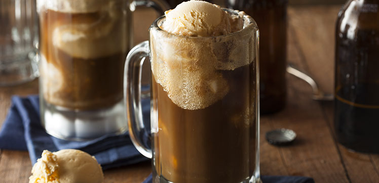 A pint of root beer with ice cream on top.