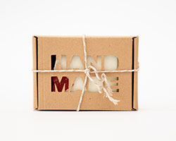 A paperboard box for soap wrapped with twine.