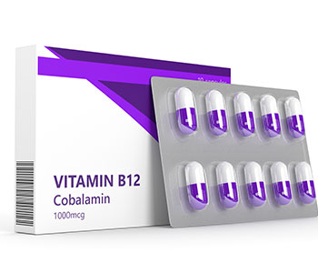Vitamins in a blister and a white box of vitamin B12.