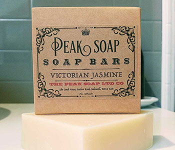 Paperboard soap box that reads "Peak Soap" on top of the soap bar.